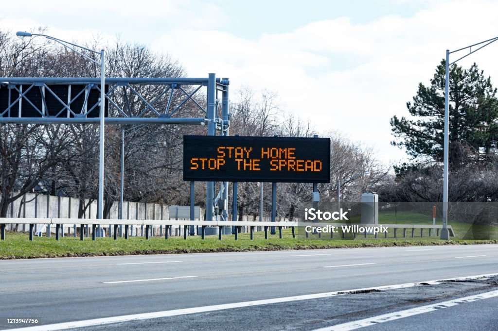 New York State Expressway Road Sign "Stay Home Stop the Spread" Covid-19 Coronavirus Rochester NY region highway expressway "Stay Home - Stop the Spread" road sign one day after the official New York State directive to state residents to "shelter in place" (stay home) to flatten the curve of the fast spreading coronavirus during the COVID-19 pandemic. Stay at Home Order Stock Photo