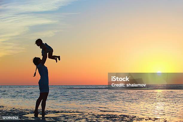 Family At Sunset Stock Photo - Download Image Now - Adult, Beach, Cheerful