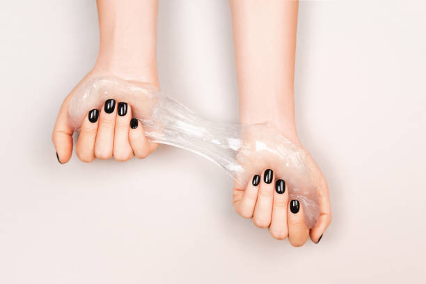istock Black manicure holding slime 1213960842