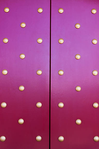 istock Closeup purple door with golden buttons, copy space 121396111