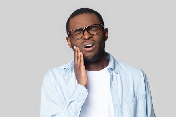istock Head shot unhappy African American man suffering from toothache 1213961288