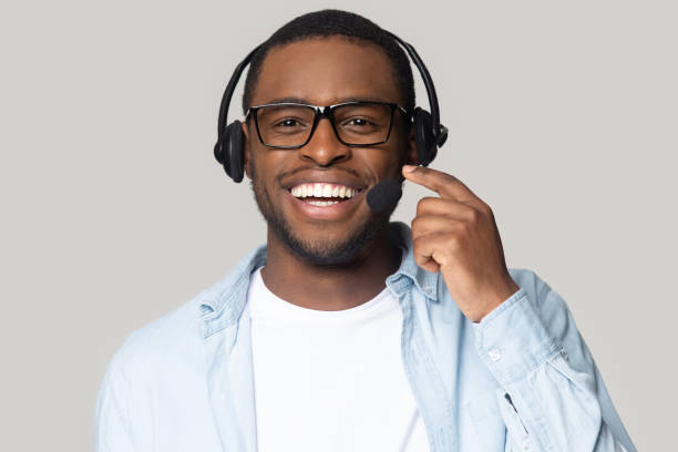 tiro na cabeça sorrindo afro-americano operador de serviço de suporte em fones de ouvido - customer service representative service african descent receptionist - fotografias e filmes do acervo