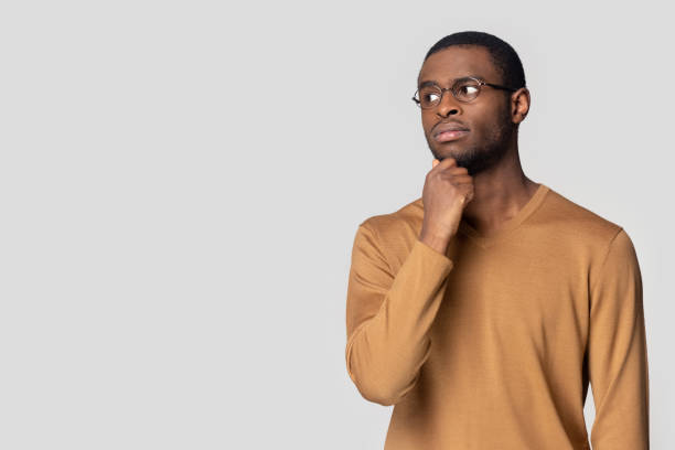 istock Thoughtful puzzled African American man looking aside at copy space 1213961316