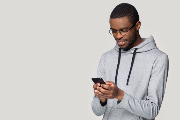 istock Smiling African American man using phone with copy space aside 1213961348