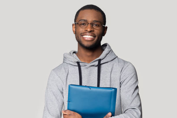 istock Head shot portrait smiling African American man holding folder 1213961370