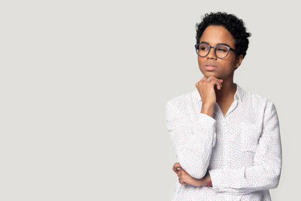 istock Thoughtful puzzled African American woman looking aside at copy space 1213961420
