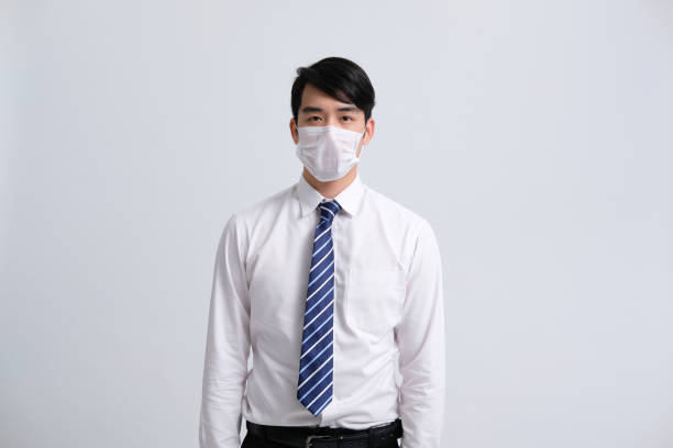 istock businessman man wearing protective mask against cold flu virus bacteria infection pollution 1213961563
