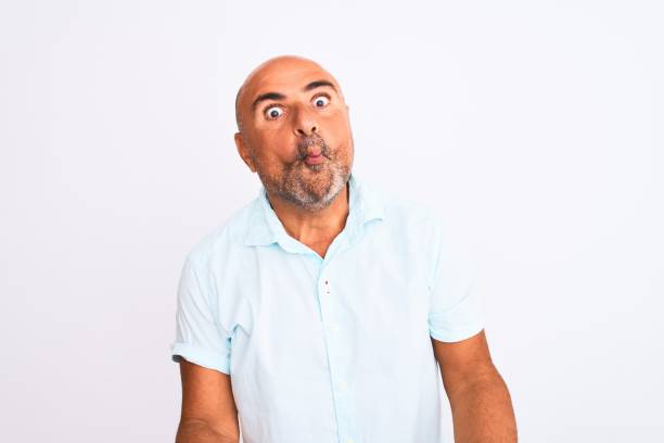 istock Middle age handsome man wearing casual shirt standing over isolated white background making fish face with lips, crazy and comical gesture. Funny expression. 1213962690