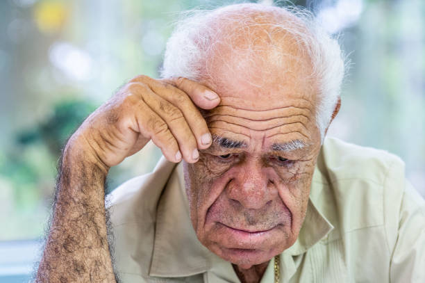 istock Sad, sick, very old man looking down very concerned 1213973006