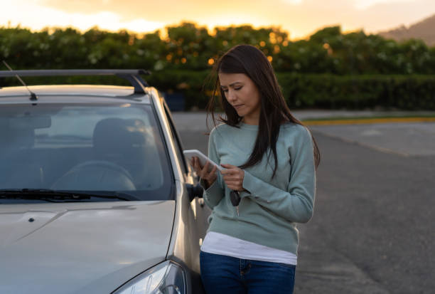 istock Beautiful woman having car problems calling her insurance 1213977377