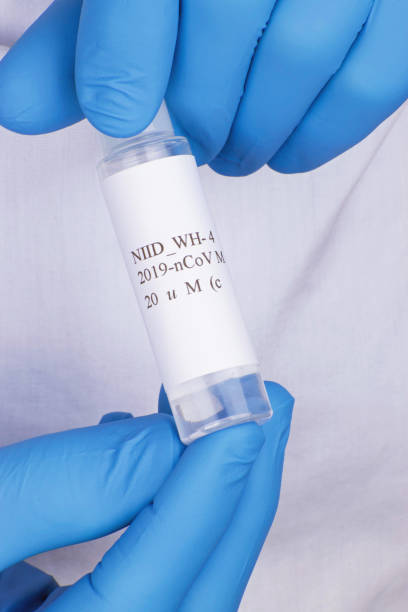 istock Coronavirus Test being held by two blue gloved hands with white background 1213978799