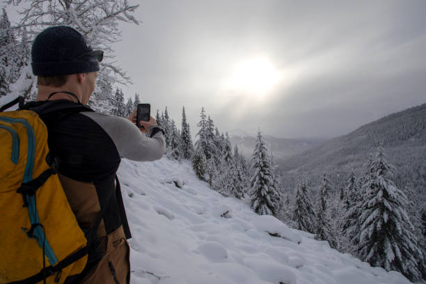 istock Back country skier pauses on mountain ridge 1213980438