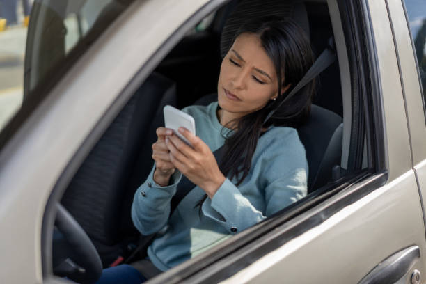 istock Woman in her car calling for roadside assistance using her smartphone 1213980471
