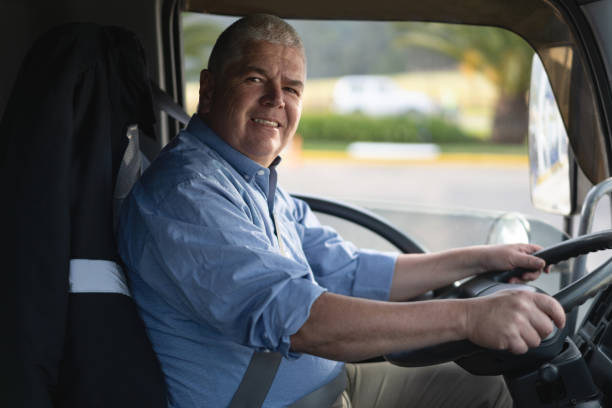 istock Friendly mature male truck driver smiling at camera 1213980533