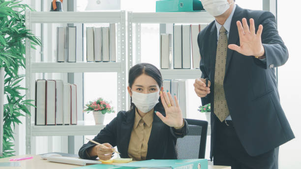istock A business team wearing a working mask 1213981243
