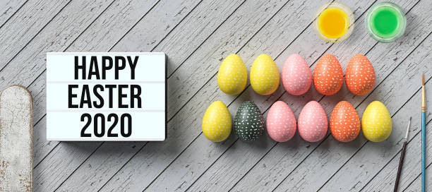 istock easter eggs and lightbox with message HAPPY EASTER 2020 surrounded by water color boxes 1213981278