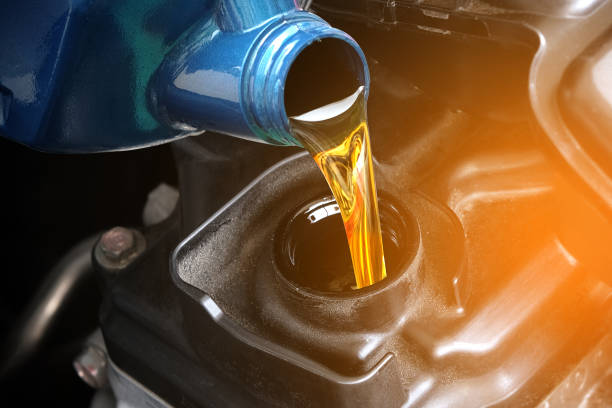 refueling and pouring oil quality into the engine motor car transmission and maintenance gear .energy fuel concept. - lubrication imagens e fotografias de stock