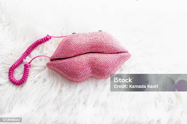 Pink Sequin Lip Shape Telephone With Fluffy White Background 80s Retro Style Old Fashion Stock Photo - Download Image Now