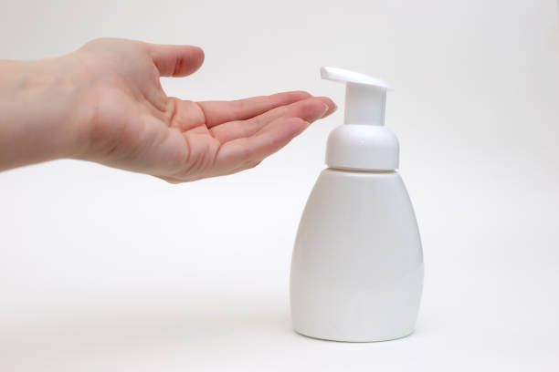 istock Hand on a white background with a white bottle of antibacterial soap 1213993334