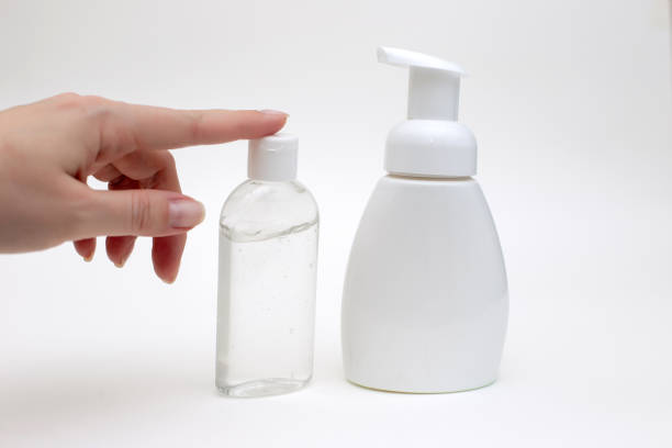 istock Hand on a white background with a white bottle of antibacterial soap 1213993357