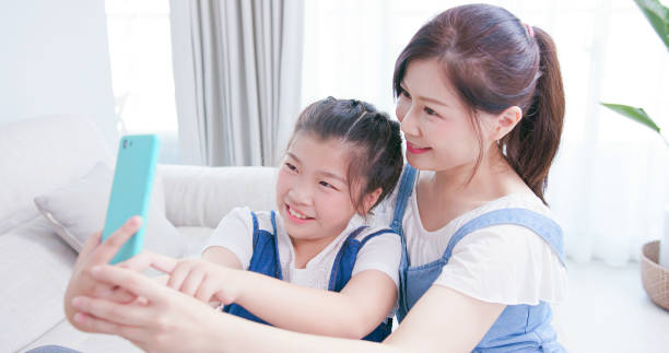 istock Mom and daughter take selfie 1213993419