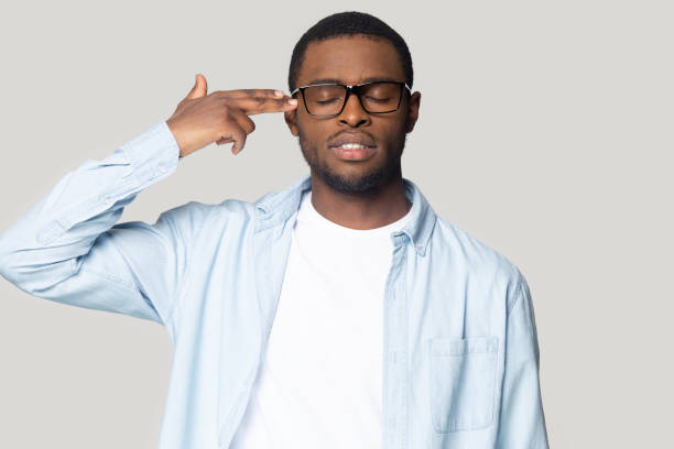 istock Head shot upset African American puts finger gun gesture 1213997639