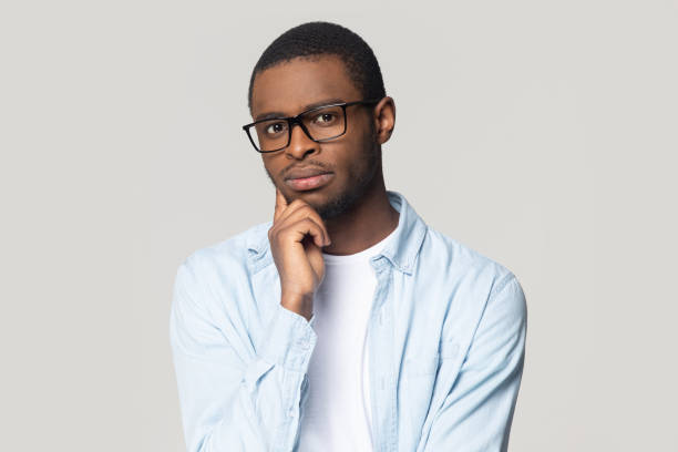 istock Head shot portrait puzzled African American man pondering idea 1213997640