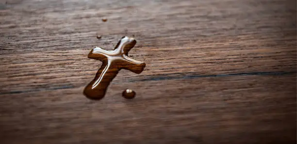 Water drops cross on beautiful wood grain