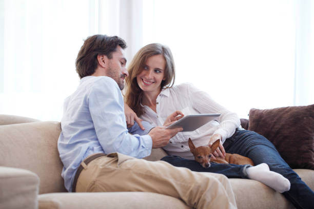 istock Couple at home with pet dog 1214002925