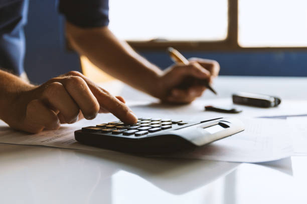 istock businessman working in office with soft-focus and over light in the background 1214003770