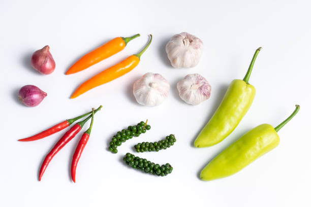 Group of various fresh pepper varieties on white background, copy space