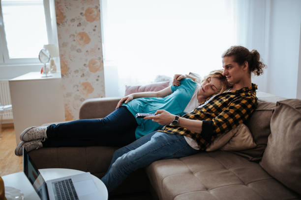 istock Couple watching tv at home 1214004138
