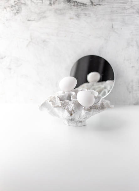 istock white eggs and coral on a white background with copy space 1214004759