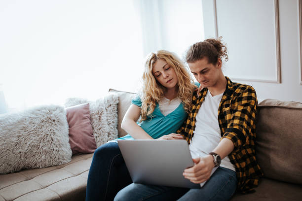 istock Couple using laptop at home 1214005001