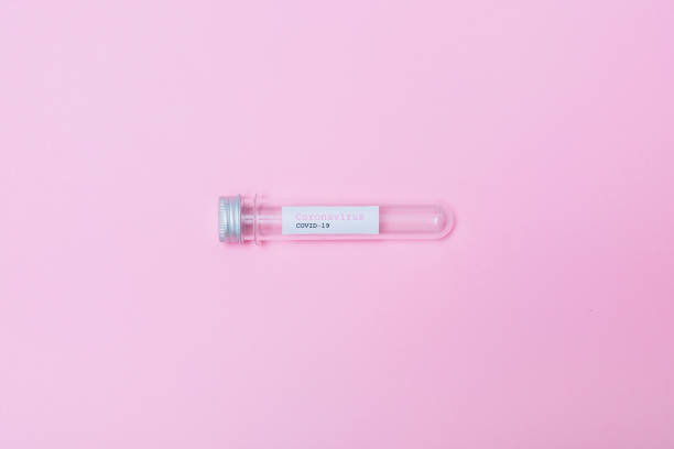 istock COVID-19 test and empty laboratory sample for diagnosis new Coronavirus infection on pink background. Pandemic creative concept. 1214005021