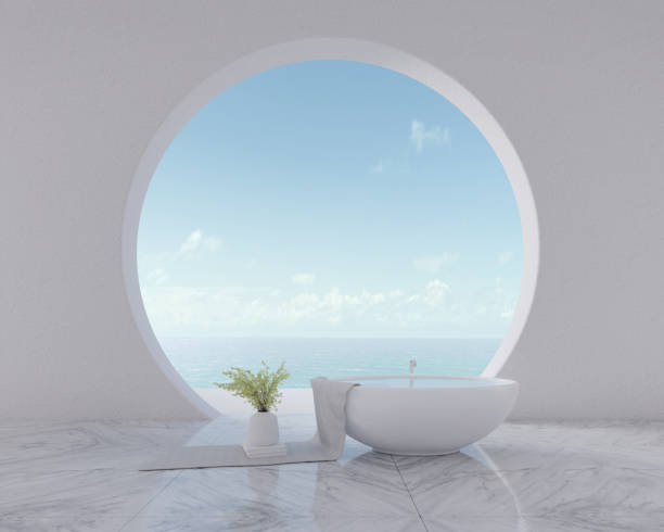 istock Sea view from circle window with bathtub and vase on towel.Modern interior design 1214005771