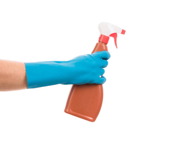istock Hand in gloves holds a spray bottle. 1214014422
