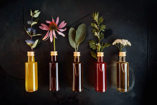 Photo of Various herbal oils with flowers