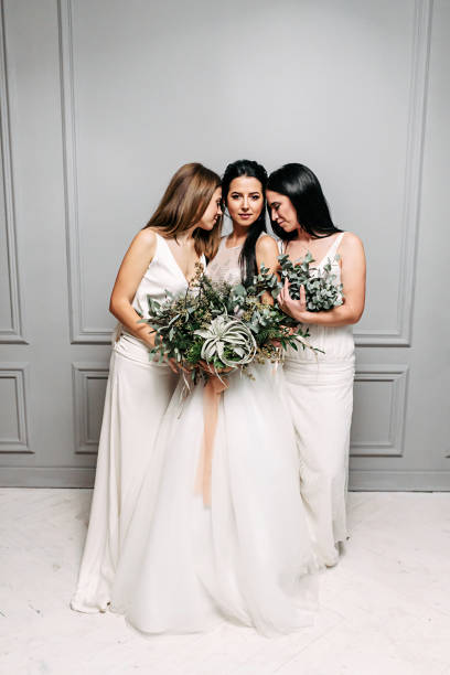 istock Bride and bridesmaid three together in dresses 1214015794
