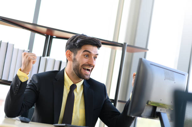 istock Happy excited businessman celebrate his success while looking at computer. Middle eastern businessman in office. 1214017598