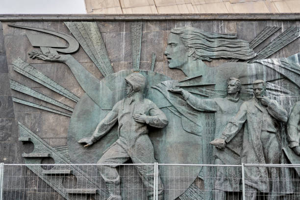 Carving Sculpture Of Soviet People On Monument Of Cosmonauts, VDNH, Moscow Bas-relief with soviet cosmonaut and scientists carved on the monument to the Conquerors of Space at the All-Russian Exhibition Center. Shooting at a winter on day, front view cosmonaut photos stock pictures, royalty-free photos & images
