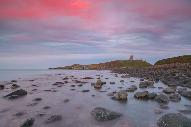 istock sunset at Dunstanburgh, sunset near Dunstanburgh 1214019788