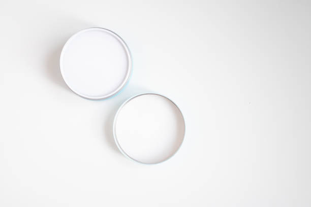 istock Closed jar of cream and lid on a white background top view 1214020110