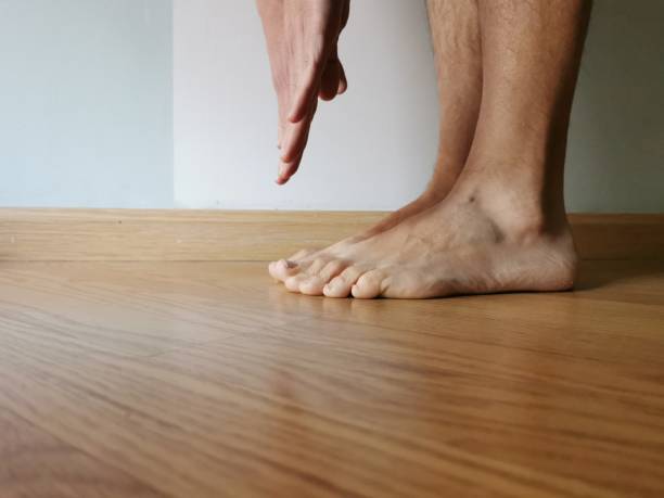 istock man doing exercise at home streatching touching feet with hands 1214021832
