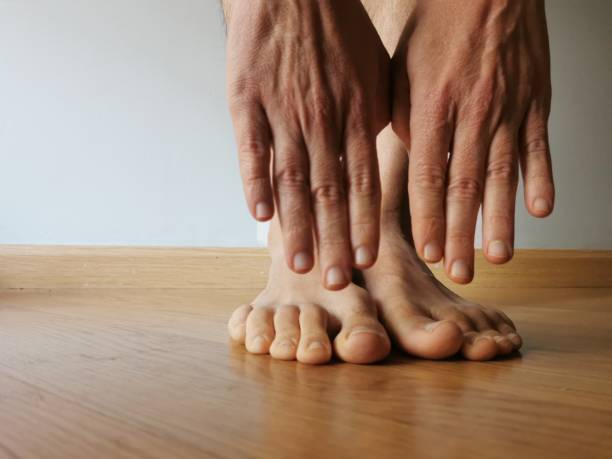 istock man doing exercise at home streatching touching feet with hands 1214021834