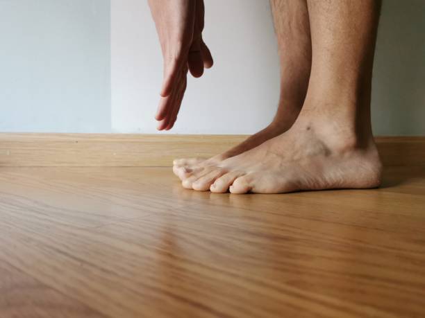 istock man doing exercise at home streatching touching feet with hands 1214021843