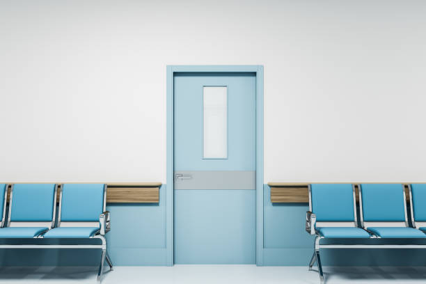 istock Row of blue chairs in empty hospital corridor 1214023156