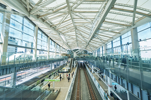 panoramic view of the interior of the Moynihan Train Hall, an expansion of Penn Station in the James Farley Building,  the main  commuter rail station in NYC.