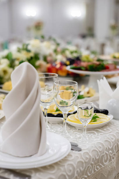 istock Vertical images of elegant dinner table setting in restaurant or hotel with wine glasses. Luxurious elegant dinner at the table. Holiday table decoration 1214024906
