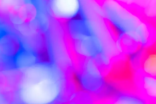 Photo of Bokeh with multi colors dots. Festive blue lights bokeh background. Defocused bokeh lights. Blurred bokeh. Light vintage background. Abstract colorful defocused pink dot. Soft focus